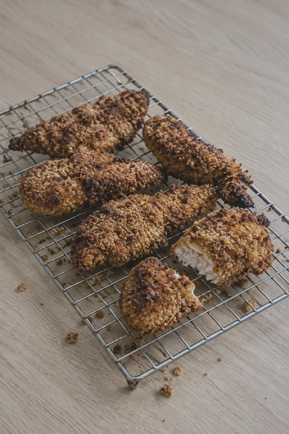 Cooked air fryer chicken tenders resting on a wire rack