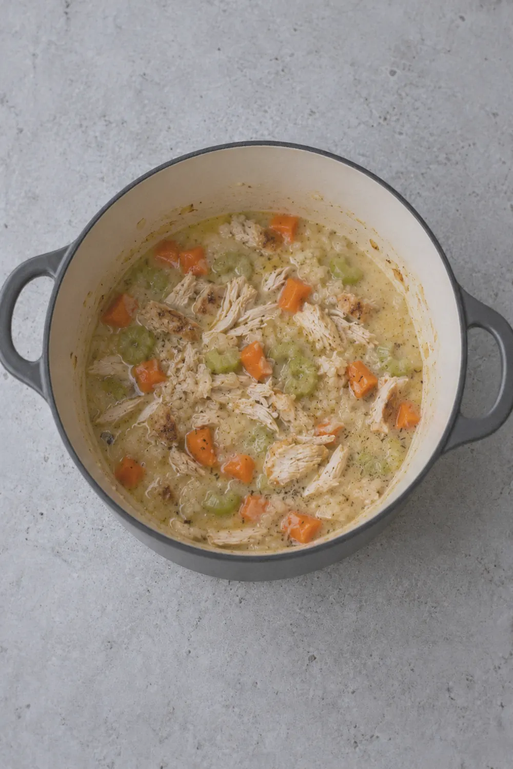 Creamy chicken pot pie soup simmering in the pot