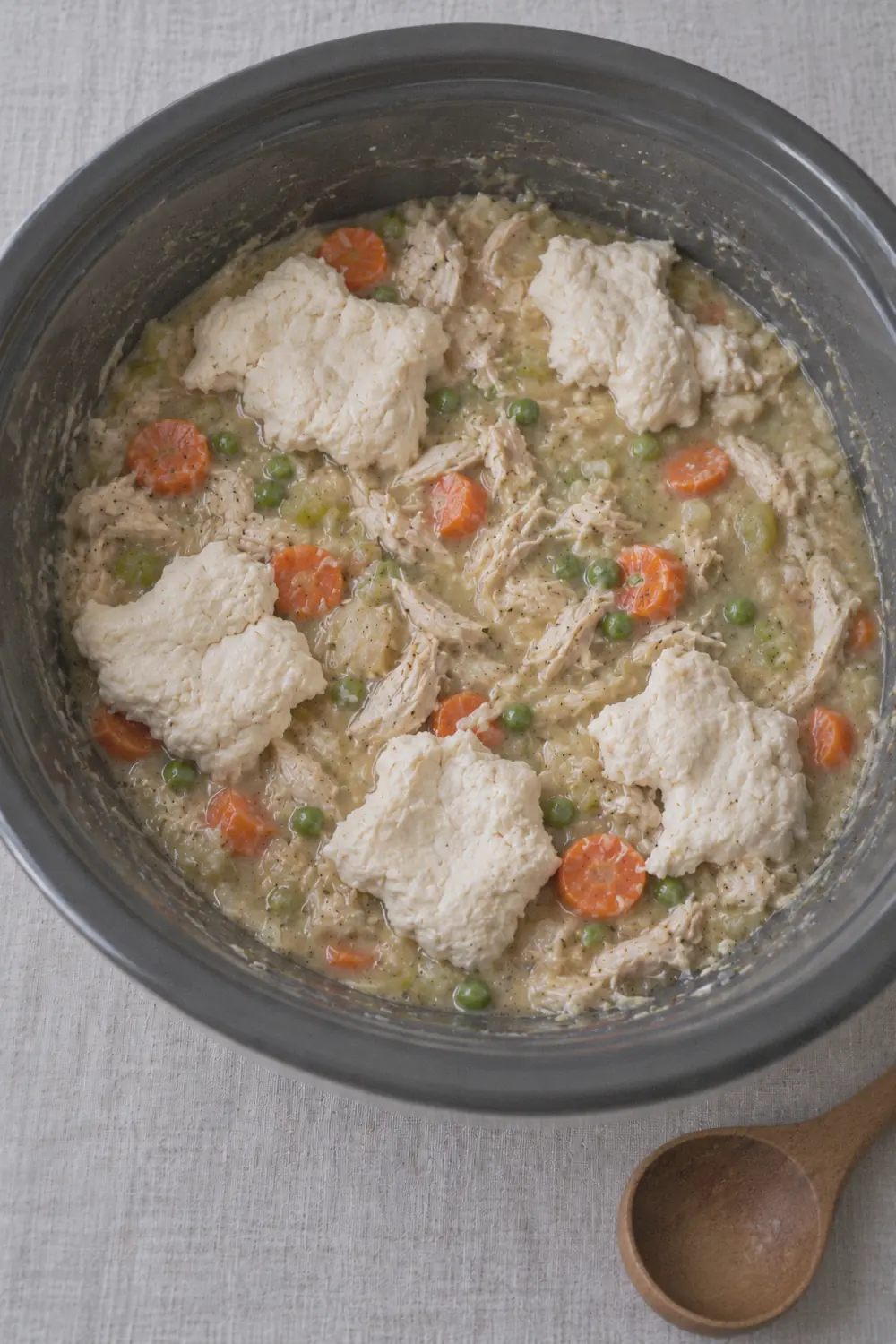 Biscuit dumplings arranged on top of the chicken stew