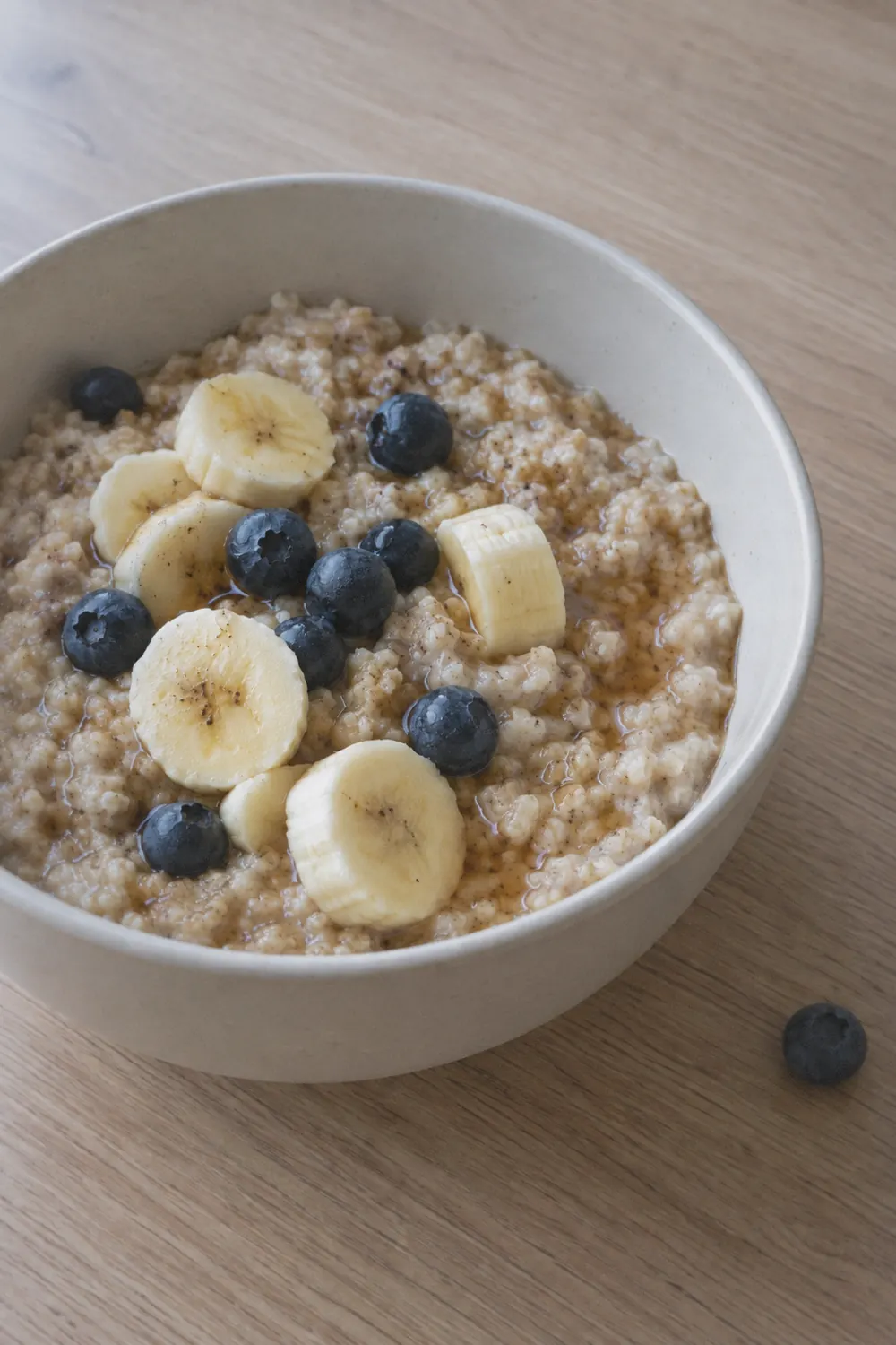 Bowl of instant pot oatmeal topped with sliced banana and blueberries